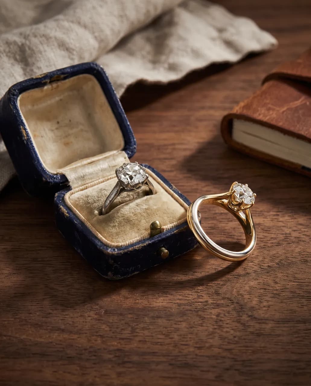 Vintage ring in a velvet box beside a new setting
